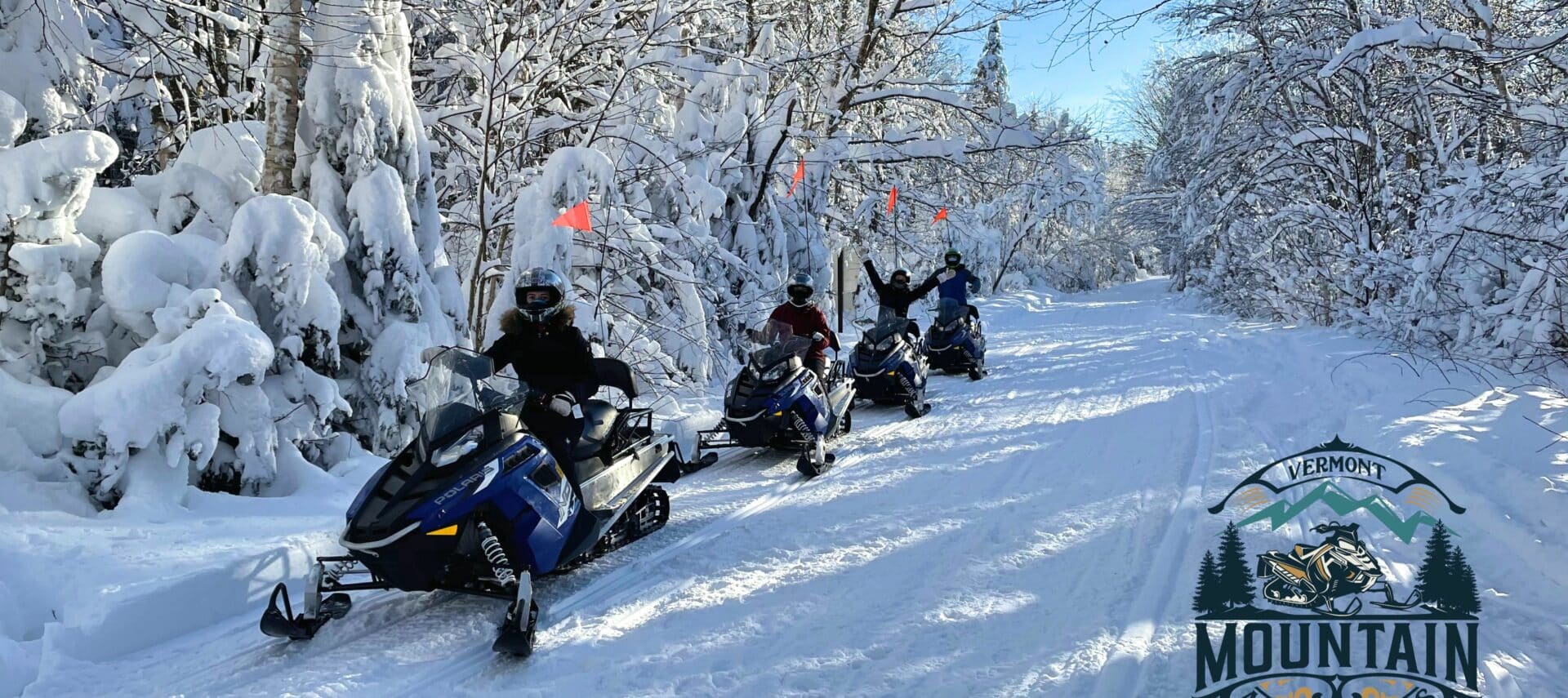 Four snowmobilers enjoying a day out in the Green Mountains