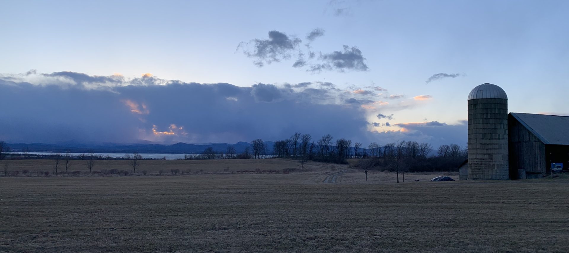 Farm land with silo at right