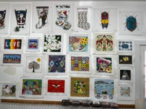 Hand-painted needlepoint templates on display