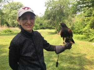 Maryann with a falcon perched on her gloved hand