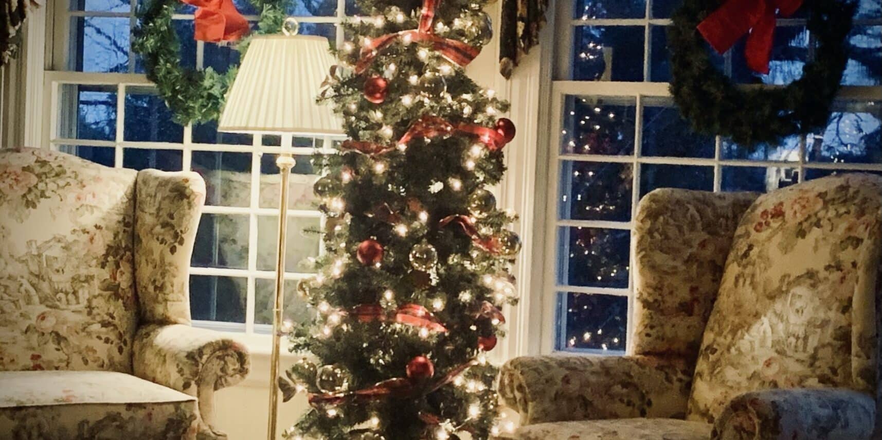 decorated christmas tree flanked by wing chairs