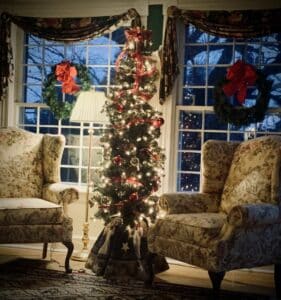 decorated christmas tree flanked by wing chairs